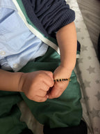 PAIR OF BLACK AND GOLD BEAD BABY BRACELETS